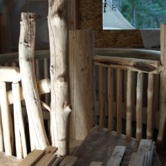 The round railing surrounding the stairwell and unique character posts | Log Spiral Stairs | Handcrafted Wood LLC