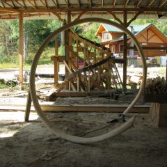 The custom curved log railing removed from the jig | Log Spiral Stairs | Handcrafted Wood LLC