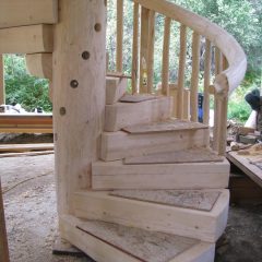 Adding the spindles to the railing and treads | Log Spiral Stairs | Handcrafted Wood LLC