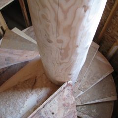 The treads are protected from wear during the construction of the rest of the home | Log Spiral Stairs | Handcrafted Wood LLC