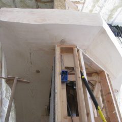 Massive custom mantle surrounding the central fireplace in the greatroom | Handcrafted Timber Accents | Handcrafted Wood LLC