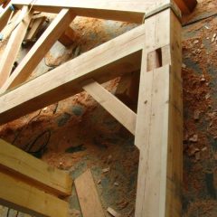 Gunstock post with mortises for knee brace, connecting girt, and bottom chord of truss | Handcrafted Wood LLC