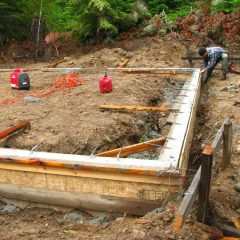 Pouring the footer for the foundation  | Timber Frame Home | Handcrafted Wood LLC