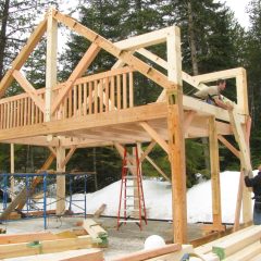 Handing up the gable ridge and rafters | Timber Frame Home | Handcrafted Wood LLC