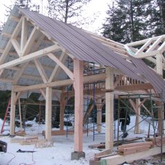 Temporary metal sheeting to protect the project from the elements | Timber Frame Home | Handcrafted Wood LLC
