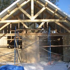 The walls are getting framed and sheathed | Timber Frame Home | Handcrafted Wood LLC