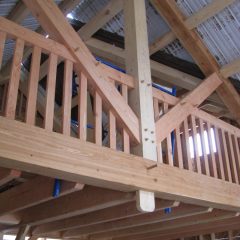 The loft above and dining room below | Timber Frame Home | Handcrafted Wood LLC