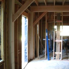 Master bedroom looking through the frame wall into the kitchen | Timber Frame Home | Handcrafted Wood LLC