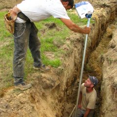 A lot of dirt work went into this project. Here we're adding a frost-free hydrant near the garden area | Timber Frame Home | Handcrafted Wood LLC