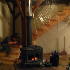 Final touches on the stairs after installation | Timber Frame Home | Handcrafted Wood LLC