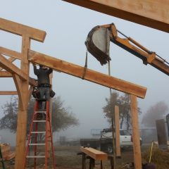 Adding the timbers for the side wings Timber Frame Barn | Handcrafted Wood LLC