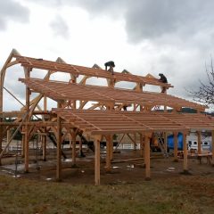 The roof build-up is going on | Timber Frame Barn | Handcrafted Wood LLC
