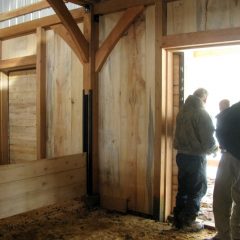 The stall dividers are low so the minis can keep each other company. Additional boards can be inserted to raise the height of the dividersAnother view of the miniature horse stalls | Timber Frame Barn | Handcrafted Wood LLC