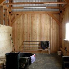 Wash room features cedar and blued pine walls and a hydrant | Timber Frame Barn | Handcrafted Wood LLC