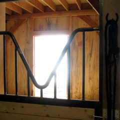 V-style social doors allow the horses to hang their heads into the aisle to say howdy | Timber Frame Barn | Handcrafted Wood LLC