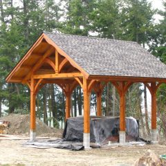 The hot tub is protected while staining the timbers | Timber Frame Hot Tub Pavilion | Handcrafted Wood LLC