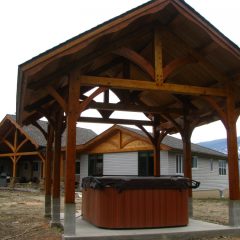 The pavilion coordinates with the house nicely | Timber Frame Hot Tub Pavilion | Handcrafted Wood LLC